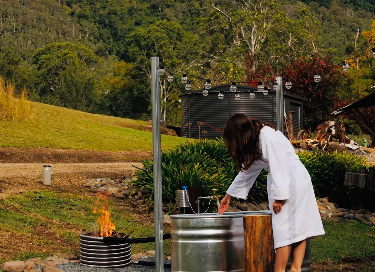 Outdoor fire tub beside a glamping tent